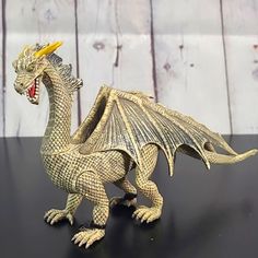 a toy dragon sitting on top of a table