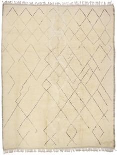 an old rug with fringes on the bottom and diagonal design in white, beige and black