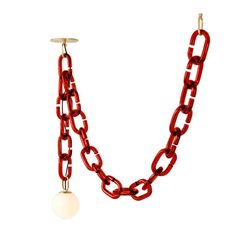 a red chain with a white ball hanging from it's end and two other chains attached to it