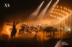 a group of people standing on top of a stage next to musical instruments and lights