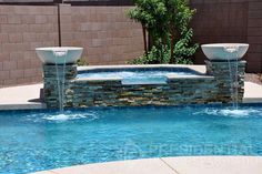 an outdoor pool with water features in the middle