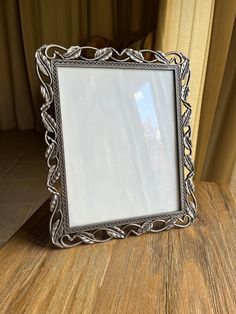 a silver frame sitting on top of a wooden table