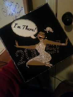 a decorated graduation cap that says i'm there with an image of a woman dancing