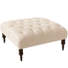 the footstool is made from wood and has an upholstered tufted fabric