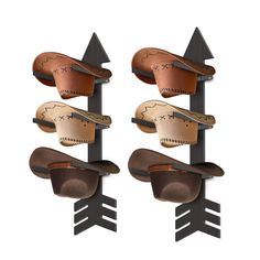 two hats are hanging on the side of a metal wall mounted hat rack with arrows