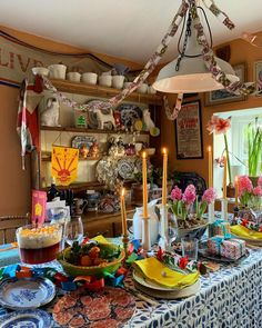 a dining room table with plates and bowls on it