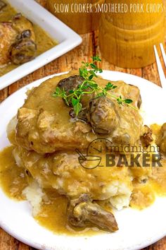 a white plate topped with meat covered in gravy