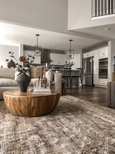 a living room filled with furniture and a large rug