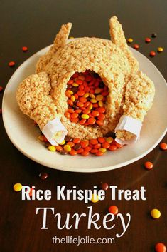 rice krispie treat turkey on a white plate with candy sprinkles around it