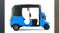 a blue three wheeled vehicle with the door open