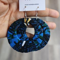 a pair of blue and black fabric earrings