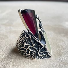 Embrace boho allure with our handcrafted silver ring, a fusion of modern  charm, and art deco finesse. This elegant piece features an agate ,garnet centerpiece, adding a touch of brutalist and gothic appeal. The wide cuff design makes it a statement accessory, perfect for those who appreciate unique, handcrafted jewelry. Each piece tells a story, making it an ideal addition to your collection or a thoughtful gift for someone special. ✅ Instructions: Remove jewelry when showering or bathing. This is particularly important when on the beach, in the sea and in chlorinated water. Never expose jewelry to household cleaning products, especially bleach and highly reactive solutions. Keep away from extreme temperatures and humidity. Modern Garnet Jewelry, Unique Garnet Jewelry, Modern Garnet Ring Jewelry, Modern Garnet Ring, Unique Handcrafted Jewelry, Wide Cuff, Armenia, Rings Statement, Handmade Ring