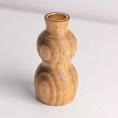 a wooden vase sitting on top of a white table