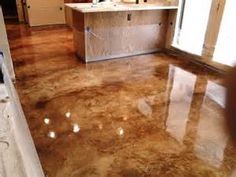 a kitchen that is being remodeled with marble flooring and cabinets in the back ground