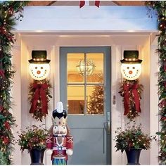 christmas decorations on the front door of a house with snowman and holiday wreaths