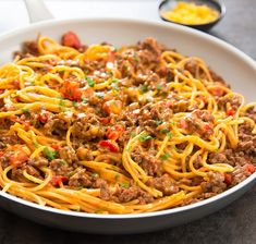 a white bowl filled with spaghetti and meat