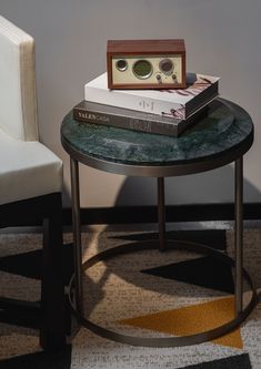 a table with two books on it next to a chair