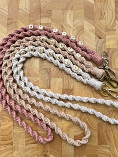 several crocheted lanyards are on a wooden floor