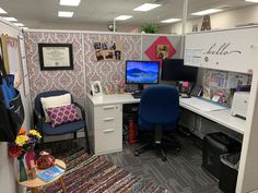 an office cubicle with two desks and chairs