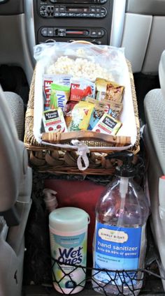 a car filled with food and drinks in the passenger side seat next to a bottle of water