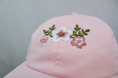 Hand Embroidered Pastel Pink Floral hat. The perfect addition to your Spring/Summer wardrobe this season, every design is hand drawn and hand embroidered onto the hat meaning that each one is individually unique. 🌿 Perfect for everyday wear or makes a great gift. 🌿 One size fits all with an adjustable buckle on the back. 🌿 The cap is 100% cotton embroidered with cotton thread. 🌿 Care instructions - Hand wash warm 30oC. ** Please note that hat colours may differ slightly due to the lighting o Cute Pink Embroidered Hat, Summer Pink Embroidered Hat, Pink Cotton Hat With Embroidered Logo, Casual Pink Embroidered Baseball Cap, Embroidered Pink Baseball Cap, Ladies Cap, Pink Baseball Hat, Hat For Summer, Festival Hat