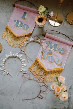 two pink and gold decorations on a table