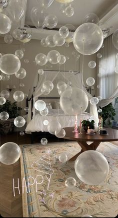 a room filled with lots of clear bubbles floating in the air over a rug and table