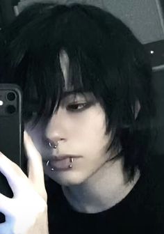 a person with piercings taking a selfie