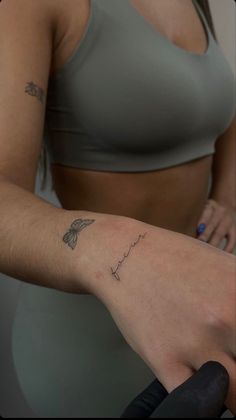 a woman with a tattoo on her arm