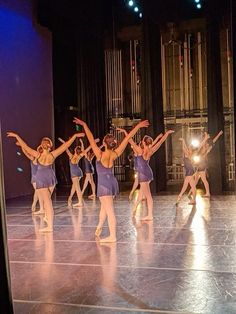 a group of young women dancing on top of a stage