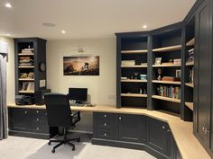 a home office with built in bookcases and desk