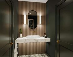 a white sink sitting under a bathroom mirror next to a wall mounted faucet