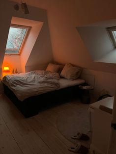 a bed sitting under a window in a bedroom