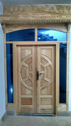 two wooden doors in front of a building