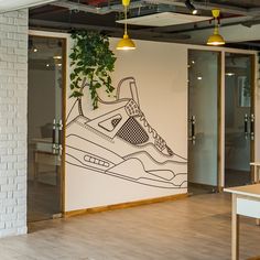 a wall with a drawing of a sneaker on it in front of a door