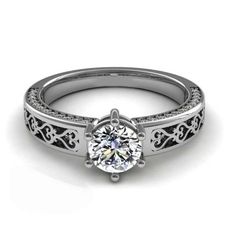 a white gold engagement ring with an intricate filigree design on the shan shan shan shan