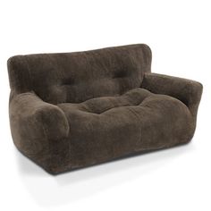 a brown couch sitting on top of a white floor