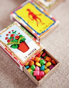 three small boxes filled with candy sitting on top of a table