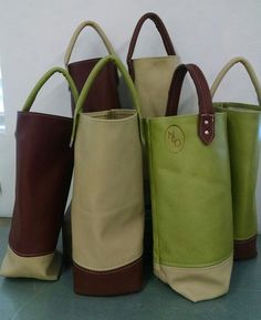 four different colored purses sitting next to each other