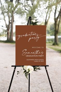 a sign that is on top of a easel with flowers in it and the words congratulations party welcome to graduates graduation party