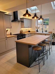 a kitchen with an island and three stools