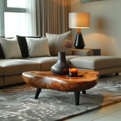 a living room with a couch, coffee table and vase on the floor in front of it