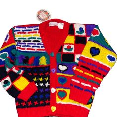 a colorful cardigan sweater with hearts and shapes on it