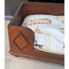 an old wooden bed with a pillow in it