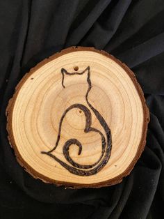 a wood slice with a cat drawn on it