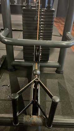 an empty gym with rows of dumbs and racks on each side, in front of the weight room