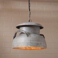 an old fashioned light hanging from a brick wall