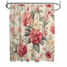 a floral shower curtain hanging on a metal rod