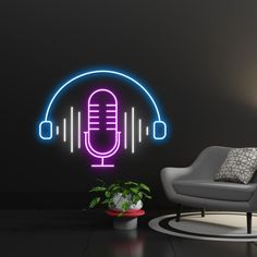 a room with a chair and a neon microphone on the wall next to a potted plant