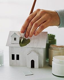 a person is painting a house with a paintbrush and some other items on the table